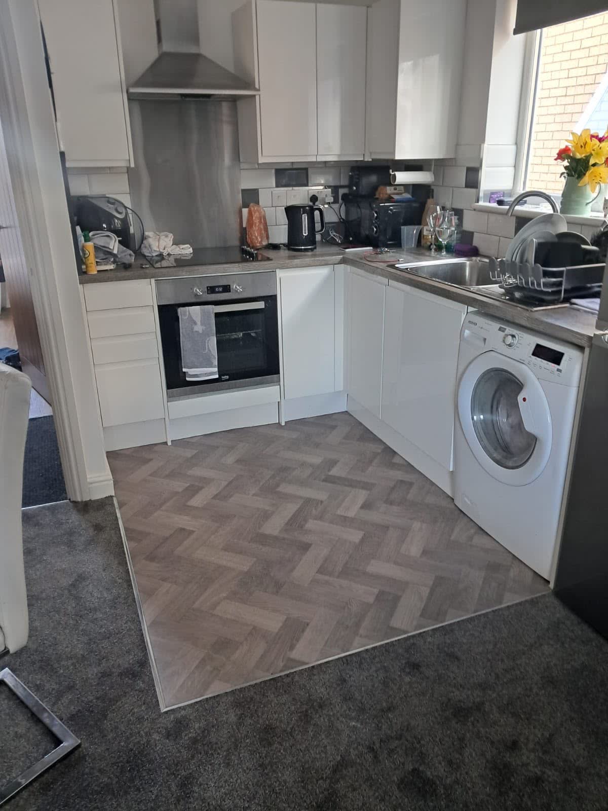 Herringbone-pattern floor in a cream kitchen