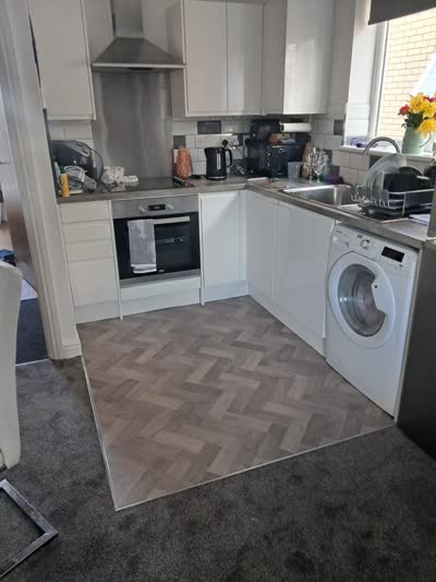 Herringbone-pattern floor in a cream kitchen