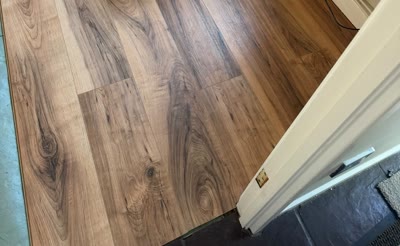 Close-up of dark oak-effect plank flooring from a second angle